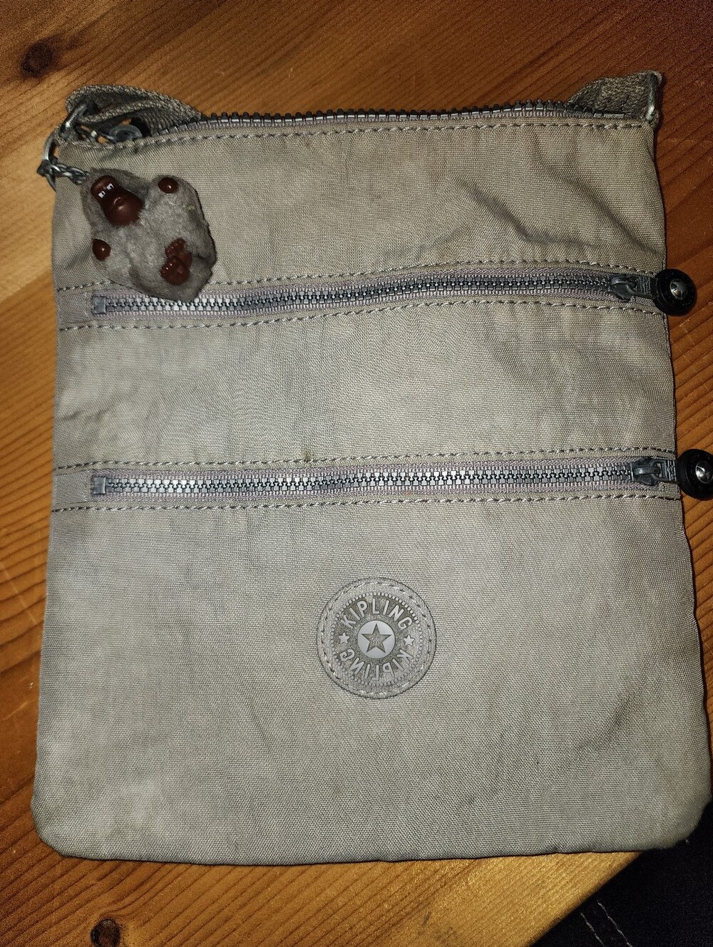 Well loved Kipling gray crossbody purse with gorilla charm